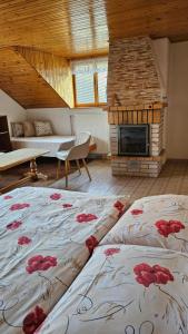 a bedroom with a bed with red flowers on it at Privát Marika in Terchová