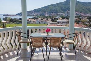 a table and chairs on a balcony with a view at Panorama Apartments in Budva
