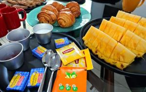 a breakfast table with pastries and croissants and bread at ZAYON - Villa AB Anziz in Pamandzi