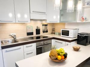 a kitchen with a bowl of fruit on a counter at Apartman Nina Selce in Selce +88 photos