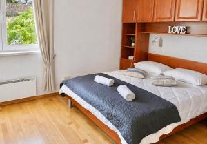 a bedroom with a bed with two towels on it at Apartman Nina Selce in Selce