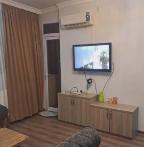 a living room with a flat screen tv on a wall at ბინა მახინჯაურში in Makhinjauri