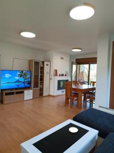 a living room with a couch and a tv and a table at Casa Agarimo in Arcade