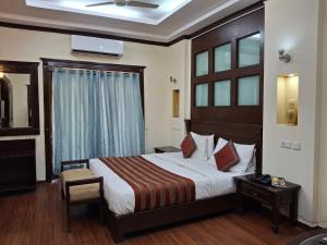 a hotel room with a bed and a window at Hotel Siris 18 in Gurgaon