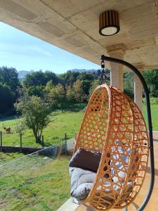 a hammock hanging from a porch with a view of a field at Casa Agarimo in Arcade