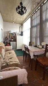a living room with a table and a refrigerator at Green side in Ganja