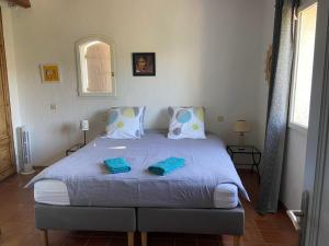 a bedroom with a large bed with blue towels on it at Lac Saint Esprit in Fréjus