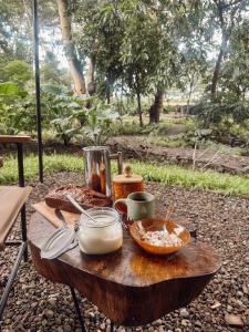 a wooden table with food on top of it at the Roost Tented Camp in Arusha