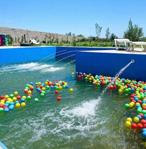 a pool of water filled with lots of colorful balls at Blue Escape in Oulad Teïma