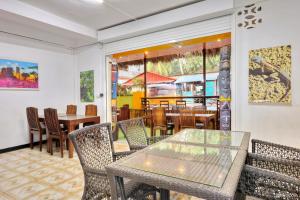 a dining room with tables and chairs and a restaurant at VaoVao Hotel in Nosy Be