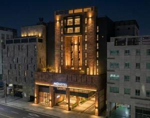 a building with a nomite sign on the side of it at MD HOTEL Dongtan in Hwaseong