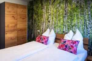 a bedroom with a bed with two pillows at Bayerwald-Bungalow in Grattersdorf +62 photos