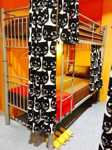 a room with two bunk beds and a curtain at CSW Hostel in Singapore