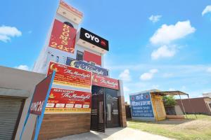 a building with signs on the side of it at Spot On Moonlight Hotel in Jhajjar +25 photos