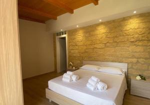 a bedroom with a bed with towels on it at Le tenute di punta bianca in Agrigento