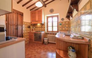 a kitchen with wooden cabinets and a counter top at Umbria Magione Podere C in Magione