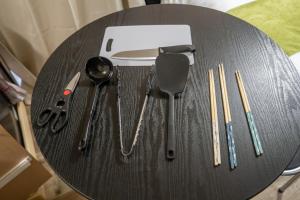 a table with utensils on top of a table at Ijiri Relax stay in Fukuoka
