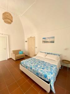 a bedroom with a bed and a chair in it at Casa Chicchella - Authentic Experience in Vieste