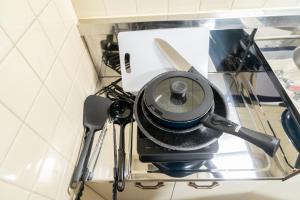 a glass table with a camera on it with utensils at Ijiri Relax stay in Fukuoka +19 photos