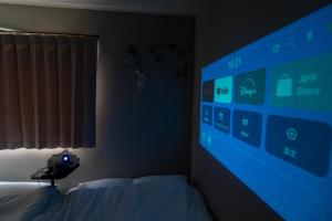 a bedroom with a bed and a large screen at Ijiri Relax stay in Fukuoka