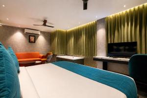 a hotel room with a bed and a tv at SKI Hotels and Resorts in Rishīkesh