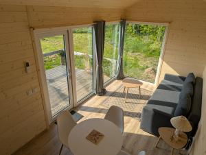 a living room with a couch and a table at Les Nids de Cerisy in Cerisy-la-Forêt