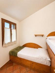 a bedroom with two beds and a window at I Cancelli -Mugello Park Family Village in Palazzuolo sul Senio +64 photos