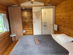 a bedroom with a bed in a wooden room at GuesthouseKAZE in Miyako-jima +190 photos
