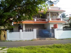 a house with a white fence and a gate at Hebron Inn in Cochin
