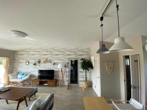 a living room with a couch and a table at GuesthouseKAZE in Miyako-jima