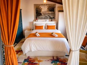 a bedroom with a bed with two stuffed animals on it at Melis House - Lake View, 75'' TV Live Football, Free Parking in Ioannina +51 photos