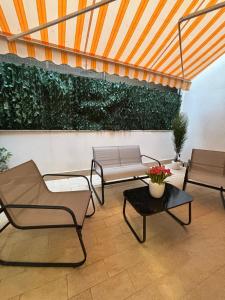 a patio with two chairs and a table at Elled-home in Misterbianco