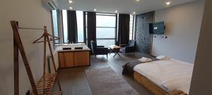 a bedroom with a bed and a desk and a sink at Merze Suit Otel in Çamlıhemşin