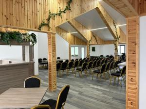a room with rows of chairs and tables at Casa Elena - Resort & SPA in Voronet +60 photos