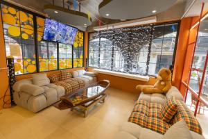 a living room with a teddy bear sitting on a couch at Hotel Rue De Siam in Chinatown