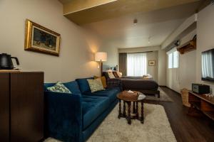 a living room with a blue couch and a table at 云溪 表參道 in Tokyo