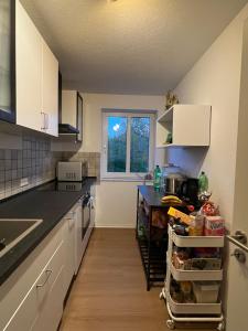 a kitchen with white cabinets and a counter top at Private Room in Oldenburg with Balcony in Shared Apartment in Hundsmühlerhöhe