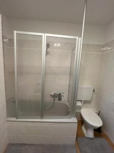 a shower stall in a bathroom with a toilet at Private Room in Oldenburg with Balcony in Shared Apartment in Hundsmühlerhöhe +2 photos