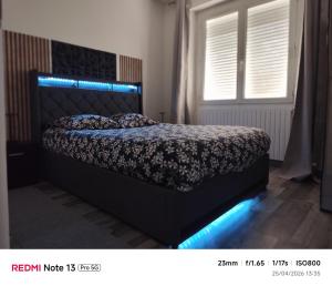 a bedroom with a bed with blue lights on it at Theviennehouse in Cenon-sur-Vienne
