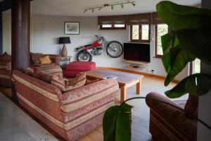 a living room with a couch and a table at Rouges Terres in Theux