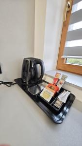 a coffee pot sitting on a tray on a counter at Noclegi Ewelina in Nowa Ruda