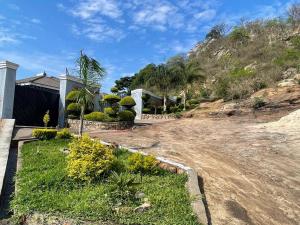 a house with a yard with grass and trees at Alamaison in Umtali