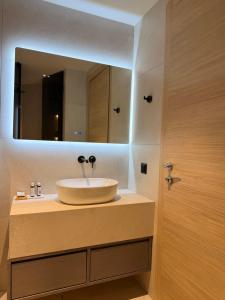 a bathroom with a sink and a mirror at Aegean Residence #A - F & B Summer Collection in Kallithea Halkidikis +21 photos