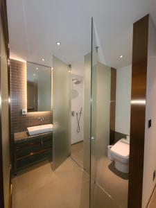 a bathroom with a glass shower and a toilet at MD HOTEL Dongtan in Hwaseong +36 photos
