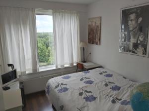 a bedroom with a bed and a window at sky home room 2 in Amsterdam