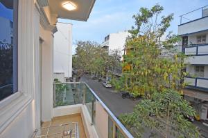 an apartment balcony with a view of a street at Hotel De Lux Splendid in Pondicherry