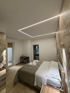 a bedroom with a bed and a table in a room at Elled-home in Misterbianco