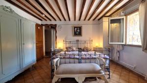 a bedroom with a metal bed in a room at La Bergerie Du Moulin - Espace sans enfants in Taradeau +132 photos
