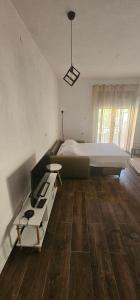 a large bedroom with a large bed and a desk at Apartments Agnes in Dobrota