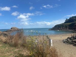 a beach with a group of boats in the water at Maison, atypique, proche, mer in Plérin